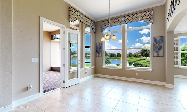 3653 Oglebay Dr, Green Cove Springs, FL 32043 - unfurnished dining area featuring crown molding, healthy amount of natural light, baseboards, and arched walkways