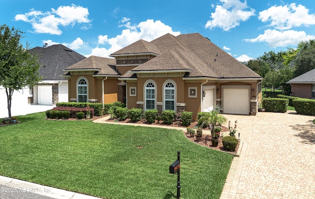 3653 Oglebay Dr, Green Cove Springs, FL 32043 - view of front of property with a garage, stucco siding, decorative driveway, stone siding, and a front yard