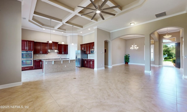 3653 Oglebay Dr, Green Cove Springs, FL 32043 - kitchen with reddish brown cabinets, stainless steel appliances, open floor plan, under cabinet range hood, and a ceiling fan