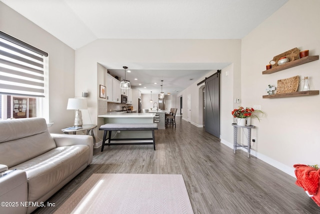 212 Foxcross Ave, Saint Johns, FL 32092 - living room featuring wood finished floors, lofted ceiling, and baseboards