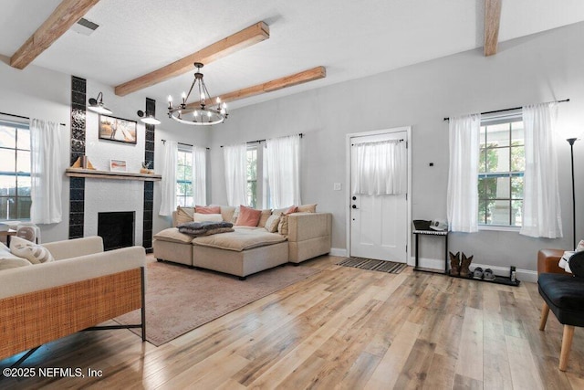 3040 Rosselle St, Jacksonville, FL 32205 - living area featuring beam ceiling, plenty of natural light, wood finished floors, and a chandelier