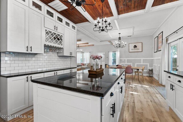 3040 Rosselle St, Jacksonville, FL 32205 - kitchen with a chandelier, coffered ceiling, light wood-type flooring, decorative backsplash, and white cabinetry