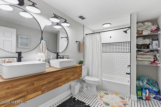 3040 Rosselle St, Jacksonville, FL 32205 - bathroom featuring shower / bath combination with curtain, double vanity, toilet, tile patterned flooring, and baseboards