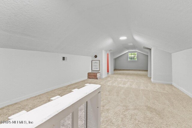3040 Rosselle St, Jacksonville, FL 32205 - additional living space with a textured ceiling, lofted ceiling, carpet floors, and baseboards