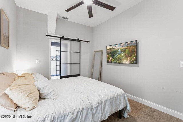3040 Rosselle St, Jacksonville, FL 32205 - carpeted bedroom with a barn door, baseboards, and ceiling fan