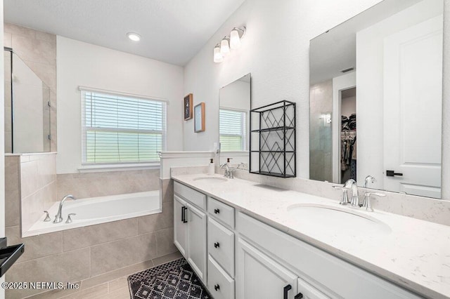 154 Pine Candle Way, Saint Augustine, FL 32092 - full bath with double vanity, a bath, a walk in closet, and a tile shower