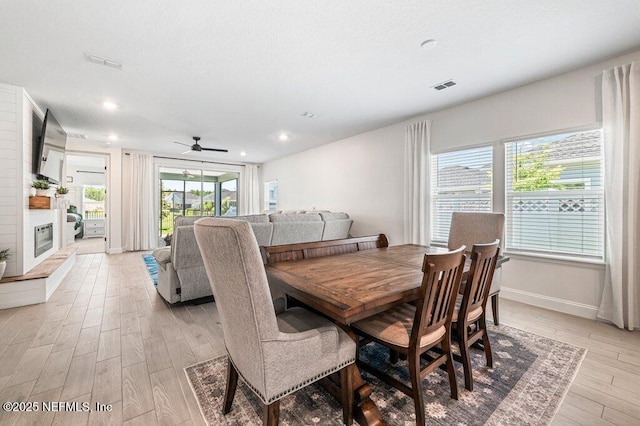 154 Pine Candle Way, Saint Augustine, FL 32092 - dining space featuring light wood finished floors, a ceiling fan, a fireplace, recessed lighting, and baseboards