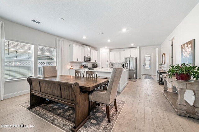 154 Pine Candle Way, Saint Augustine, FL 32092 - dining space featuring light wood-style floors, healthy amount of natural light, baseboards, recessed lighting, and a textured ceiling