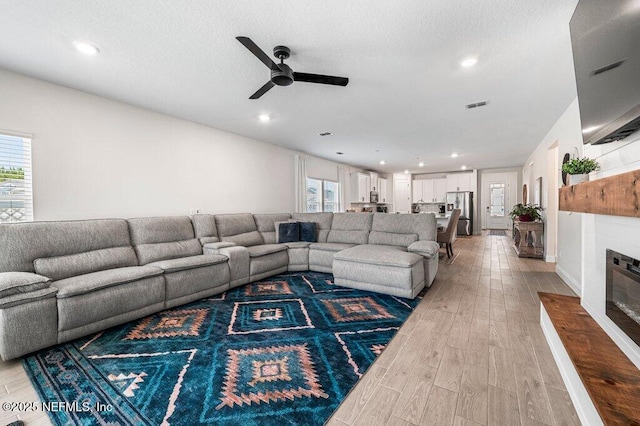 154 Pine Candle Way, Saint Augustine, FL 32092 - living area featuring light wood-type flooring, ceiling fan, a glass covered fireplace, and recessed lighting