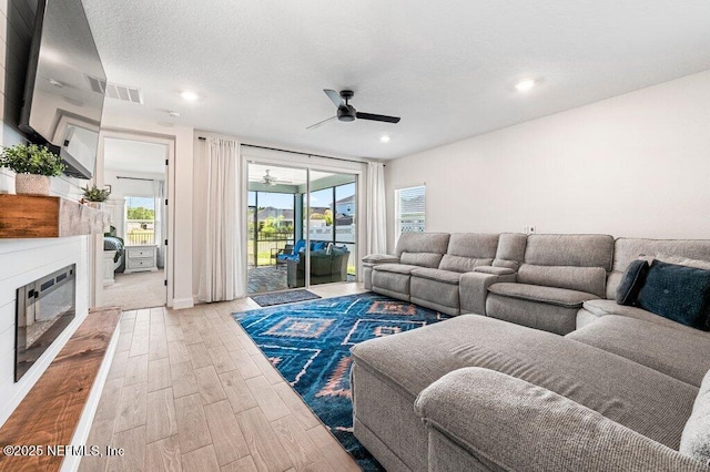 154 Pine Candle Way, Saint Augustine, FL 32092 - living area featuring a ceiling fan, light wood finished floors, a glass covered fireplace, recessed lighting, and baseboards