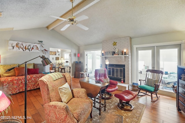 11019 Crumpet Ct, Jacksonville, FL 32257 - living room with hardwood / wood-style floors, a textured ceiling, ceiling fan, a fireplace, and french doors