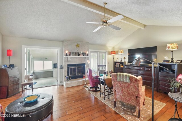 11019 Crumpet Ct, Jacksonville, FL 32257 - living area with plenty of natural light, hardwood / wood-style flooring, a ceiling fan, a textured ceiling, and a fireplace