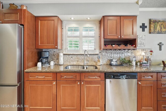 11019 Crumpet Ct, Jacksonville, FL 32257 - kitchen featuring appliances with stainless steel finishes, a sink, crown molding, backsplash, and light stone counters