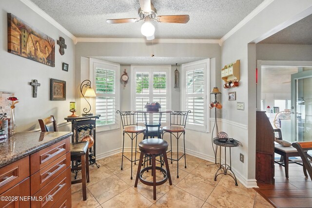 11019 Crumpet Ct, Jacksonville, FL 32257 - dining space with ceiling fan, a textured ceiling, ornamental molding, and light tile patterned flooring