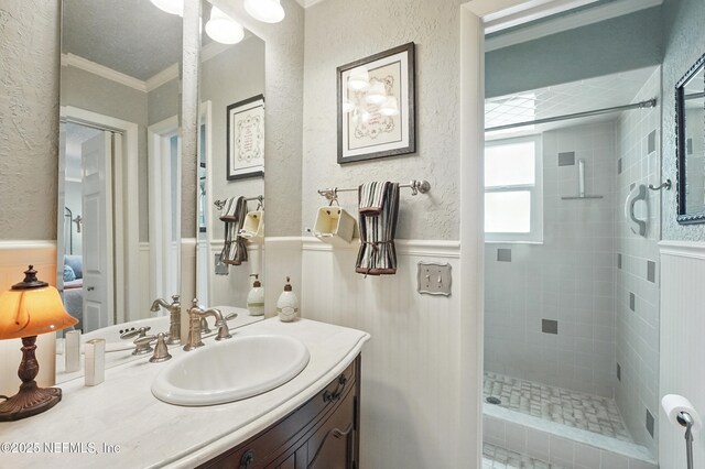 11019 Crumpet Ct, Jacksonville, FL 32257 - full bath with ornamental molding, vanity, a shower stall, wainscoting, and a textured wall