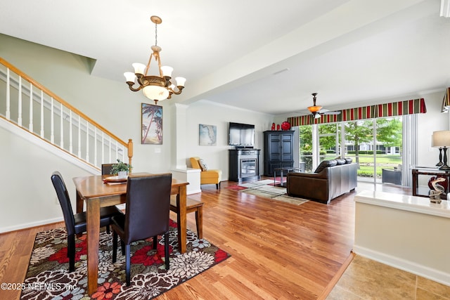 3724 Windmaker Way, Jacksonville, FL 32224 - dining space featuring stairway, a chandelier, light wood-style flooring, and baseboards