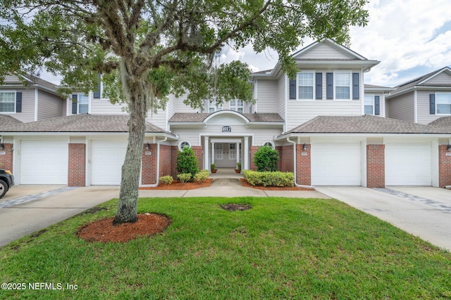 2017 Pond Ridge Ct Unit 1003, Fleming Island, FL 32003 - multi unit property with driveway, brick siding, and a front lawn
