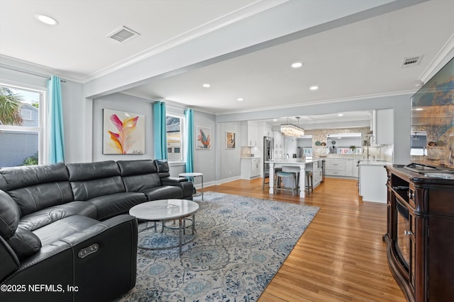 536 14th Ave N, Jacksonville Beach, FL 32250 - living area featuring ornamental molding, light wood-type flooring, recessed lighting, and a chandelier