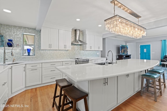 536 14th Ave N, Jacksonville Beach, FL 32250 - kitchen featuring wall chimney range hood, stainless steel electric stove, a chandelier, a sink, and crown molding