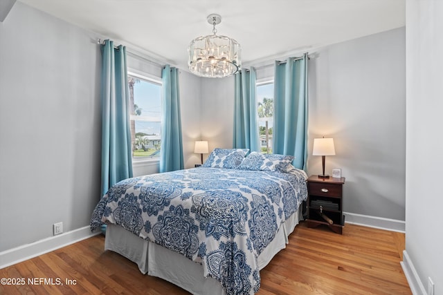 536 14th Ave N, Jacksonville Beach, FL 32250 - bedroom featuring a chandelier, multiple windows, wood finished floors, and baseboards