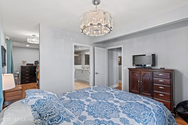 536 14th Ave N, Jacksonville Beach, FL 32250 - bedroom with a chandelier, wood finished floors, and ensuite bathroom
