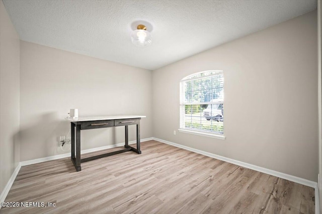 86045 Harrahs Pl, Yulee, FL 32097 - unfurnished room with wood finished floors, baseboards, and a textured ceiling