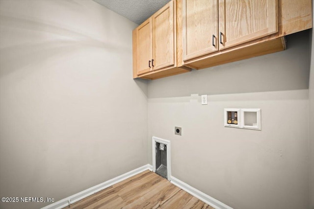 86045 Harrahs Pl, Yulee, FL 32097 - laundry room featuring cabinet space, electric dryer hookup, washer hookup, light wood-type flooring, and baseboards