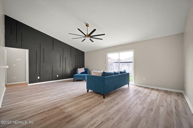 86045 Harrahs Pl, Yulee, FL 32097 - living area featuring lofted ceiling, light wood-style flooring, baseboards, and a ceiling fan