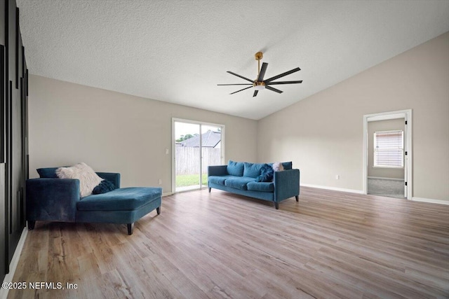 86045 Harrahs Pl, Yulee, FL 32097 - living room with lofted ceiling, ceiling fan, wood finished floors, and baseboards
