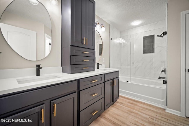 86045 Harrahs Pl, Yulee, FL 32097 - full bathroom featuring a textured ceiling, double vanity, washtub / shower combination, and wood finished floors