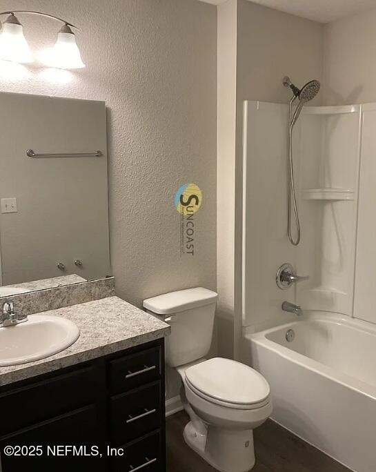 7323 Richardson Rd, Jacksonville, FL 32209 - full bath featuring vanity, toilet, bathing tub / shower combination, and a textured wall