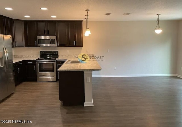 7323 Richardson Rd, Jacksonville, FL 32209 - kitchen featuring stainless steel appliances, a peninsula, baseboards, dark wood-type flooring, and light countertops