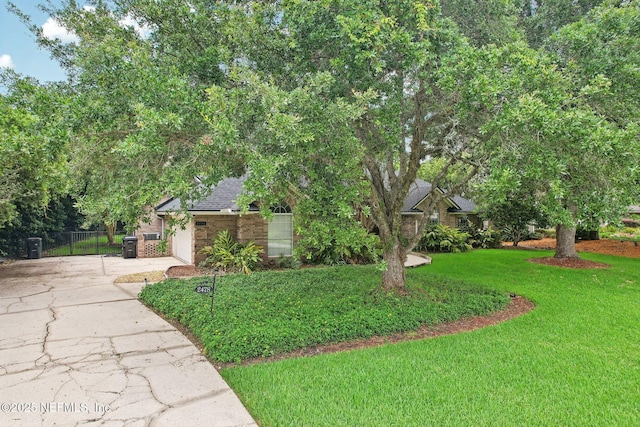 2478 Country Club Blvd, Orange Park, FL 32073 - obstructed view of property with concrete driveway, brick siding, roof with shingles, and an attached garage