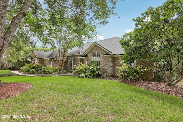 2478 Country Club Blvd, Orange Park, FL 32073 - view of front facade with a front lawn, roof with shingles, and brick siding