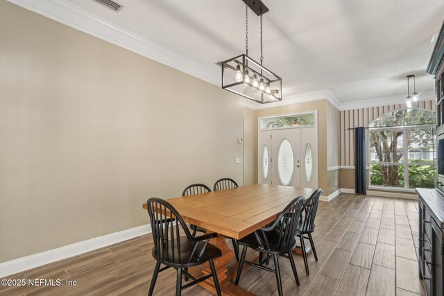 2478 Country Club Blvd, Orange Park, FL 32073 - dining area with baseboards, wood finished floors, and crown molding