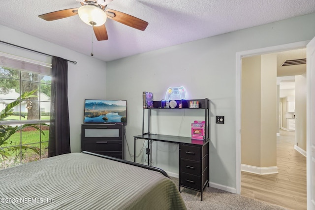 2478 Country Club Blvd, Orange Park, FL 32073 - bedroom with a textured ceiling, baseboards, ceiling fan, and wood finished floors