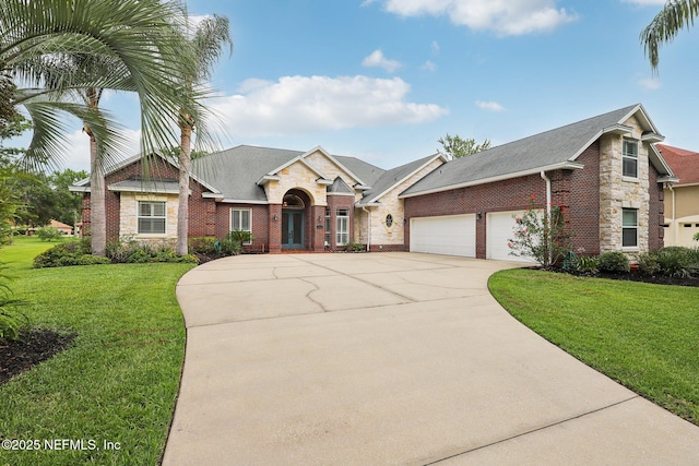 182 Malley Cove Ln, Fleming Island, FL 32003 - view of front of property with concrete driveway, an attached garage, brick siding, and a front yard