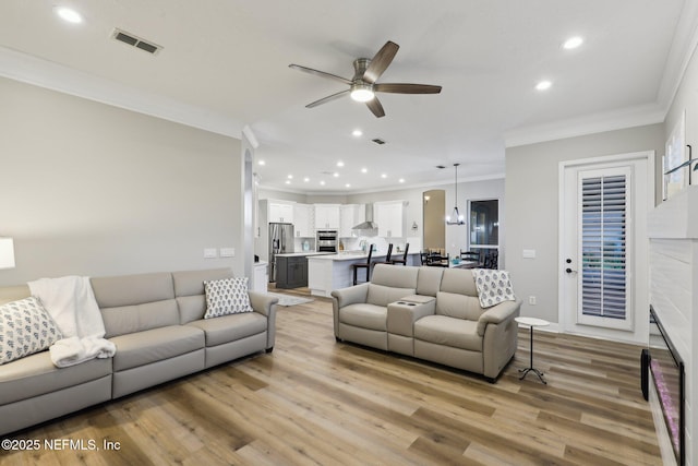 182 Malley Cove Ln, Fleming Island, FL 32003 - living area with crown molding, ceiling fan, light wood-style floors, and recessed lighting