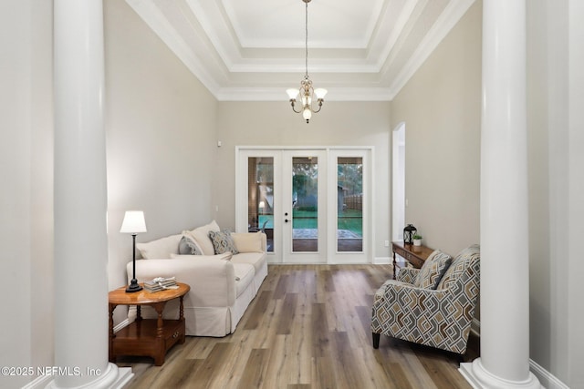 182 Malley Cove Ln, Fleming Island, FL 32003 - entrance foyer with french doors, a raised ceiling, wood finished floors, a chandelier, and crown molding