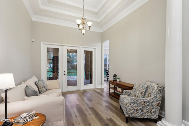 182 Malley Cove Ln, Fleming Island, FL 32003 - living area featuring french doors, wood finished floors, a chandelier, crown molding, and a raised ceiling