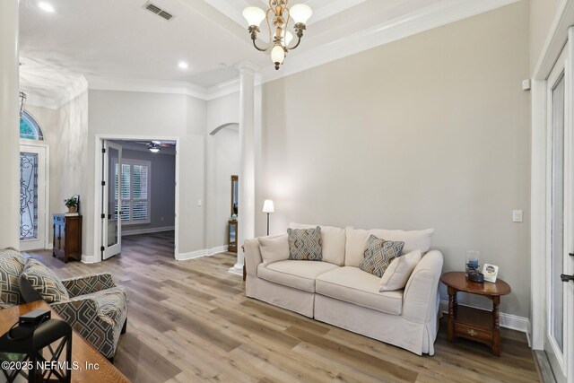182 Malley Cove Ln, Fleming Island, FL 32003 - living room featuring ornate columns, crown molding, light wood finished floors, recessed lighting, and baseboards