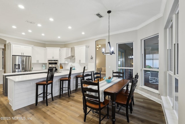 182 Malley Cove Ln, Fleming Island, FL 32003 - dining space with a chandelier, ornamental molding, light wood-style flooring, recessed lighting, and baseboards