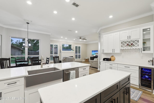 182 Malley Cove Ln, Fleming Island, FL 32003 - kitchen with beverage cooler, a sink, crown molding, recessed lighting, and light countertops