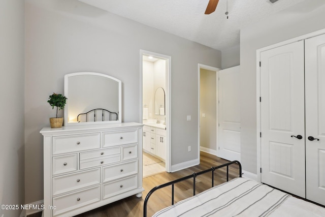 182 Malley Cove Ln, Fleming Island, FL 32003 - bedroom with wood finished floors, a closet, ensuite bathroom, baseboards, and a ceiling fan