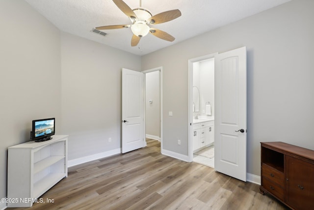 182 Malley Cove Ln, Fleming Island, FL 32003 - unfurnished bedroom featuring light wood finished floors, a sink, connected bathroom, baseboards, and a ceiling fan