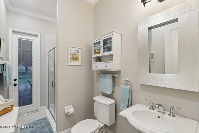 182 Malley Cove Ln, Fleming Island, FL 32003 - bathroom featuring a sink, ornamental molding, a shower stall, toilet, and tile patterned floors