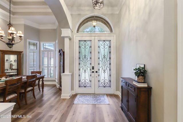 182 Malley Cove Ln, Fleming Island, FL 32003 - foyer entrance with a chandelier, french doors, wood finished floors, arched walkways, and baseboards
