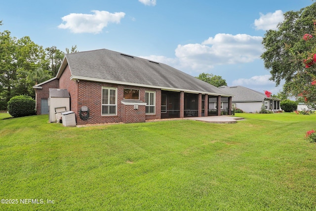 182 Malley Cove Ln, Fleming Island, FL 32003 - back of property featuring brick siding, a sunroom, a lawn, a shingled roof, and a patio