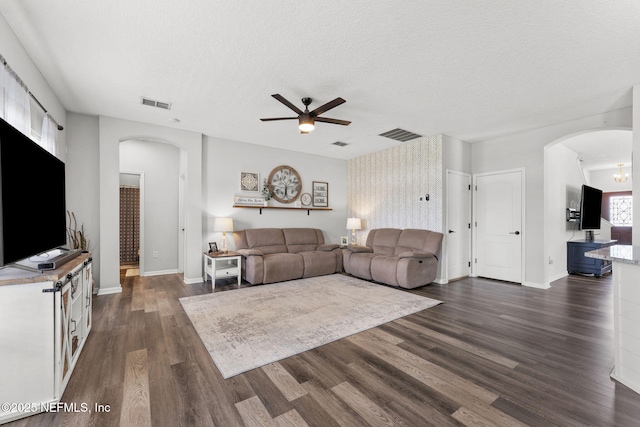 1578 Harvest Cove Dr, Middleburg, FL 32068 - living area with arched walkways, ceiling fan, dark wood-type flooring, a textured ceiling, and baseboards