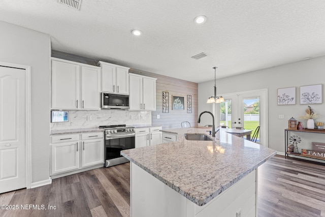1578 Harvest Cove Dr, Middleburg, FL 32068 - kitchen with appliances with stainless steel finishes, a sink, french doors, decorative backsplash, and a textured ceiling